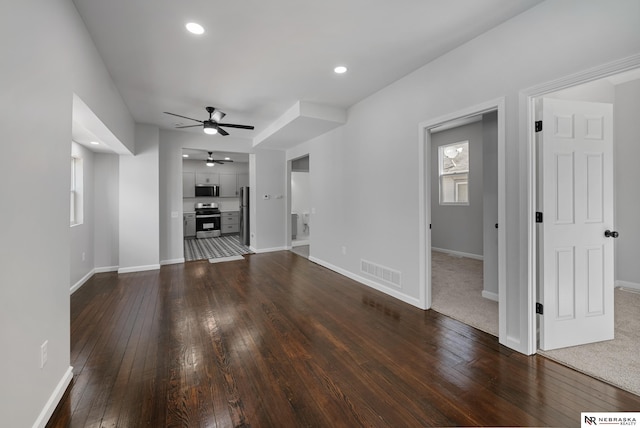 unfurnished living room with hardwood / wood-style floors and ceiling fan