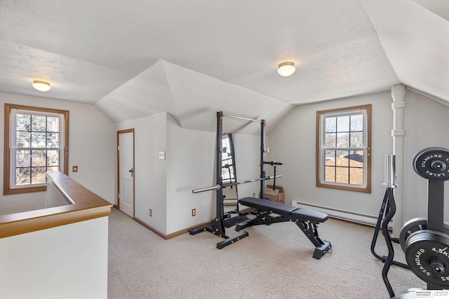 exercise room featuring a textured ceiling, vaulted ceiling, plenty of natural light, and light colored carpet