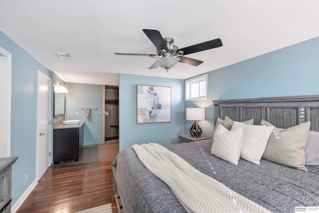 bedroom featuring ceiling fan, dark hardwood / wood-style flooring, and ensuite bathroom