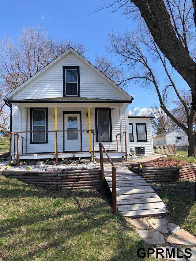 bungalow-style home with a porch and a front lawn