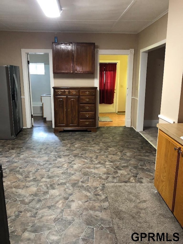 kitchen featuring fridge with ice dispenser