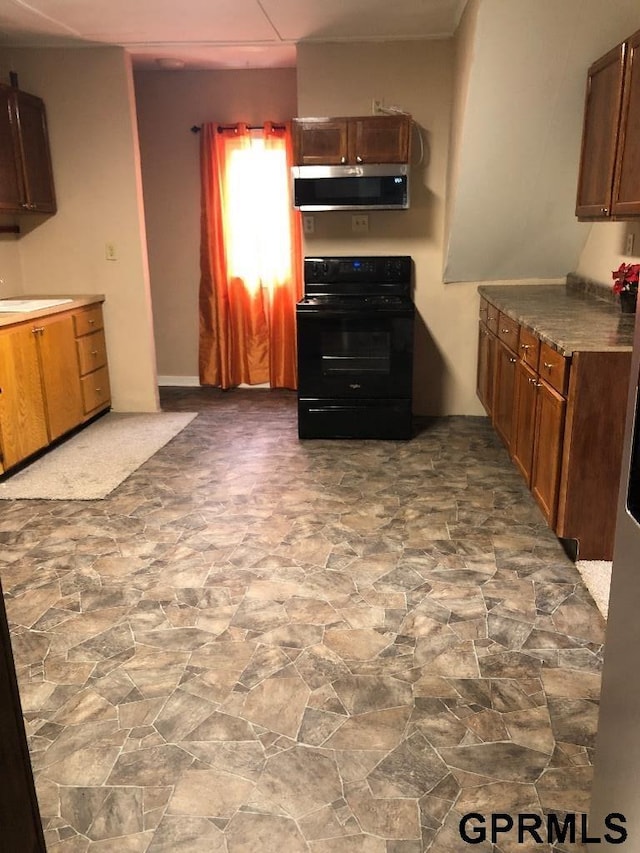 kitchen with black stove and sink