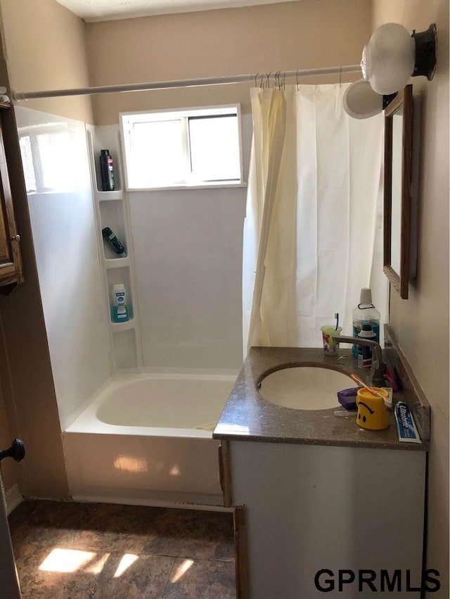 bathroom featuring shower / bath combo and vanity