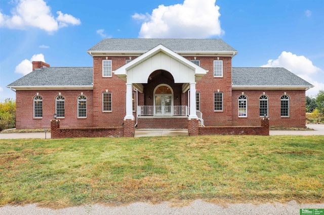 view of front of house featuring a front lawn and covered porch