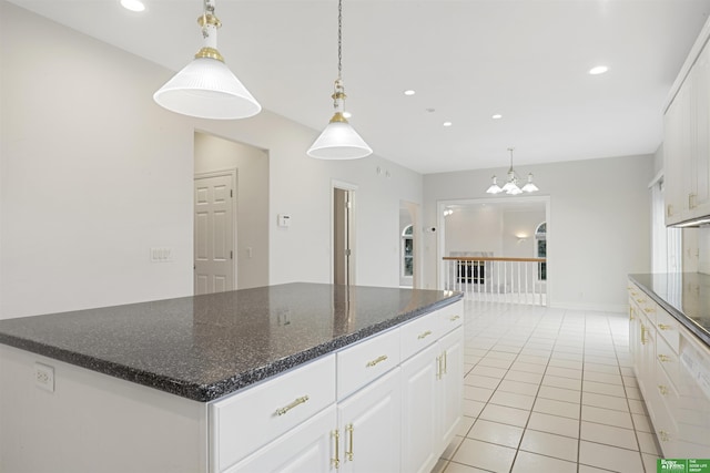 kitchen with white cabinetry, hanging light fixtures, and a kitchen island