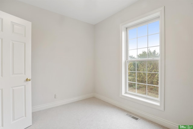 unfurnished room with light colored carpet