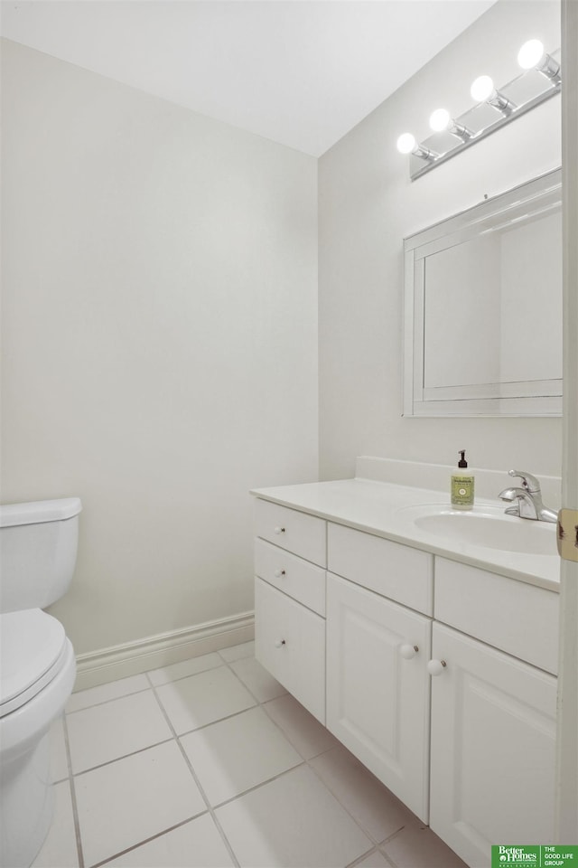 bathroom featuring tile patterned floors, vanity, and toilet