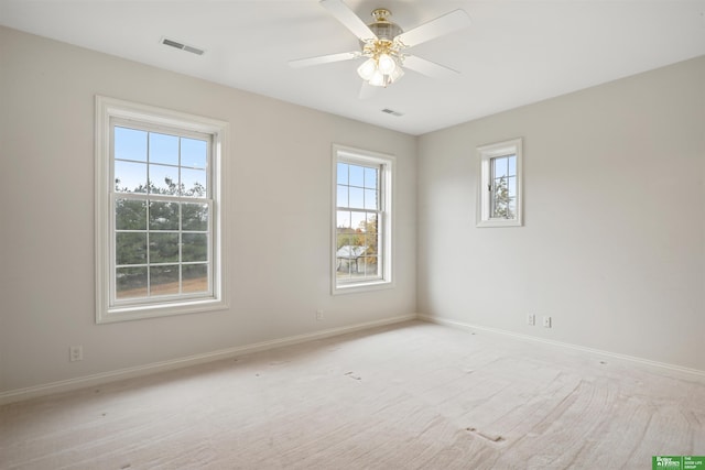 carpeted spare room featuring ceiling fan