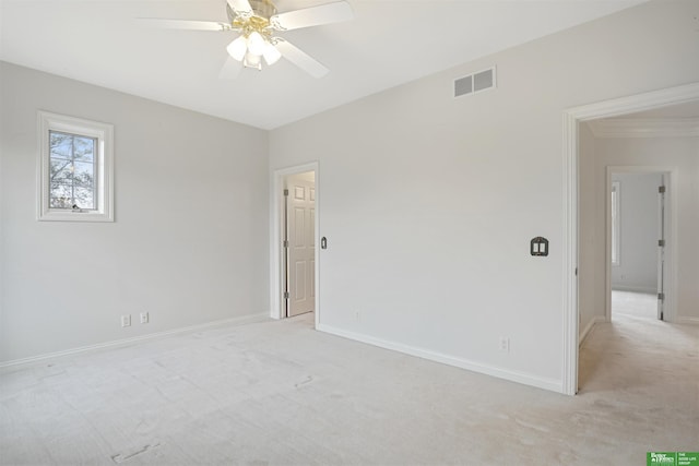 carpeted empty room featuring ceiling fan