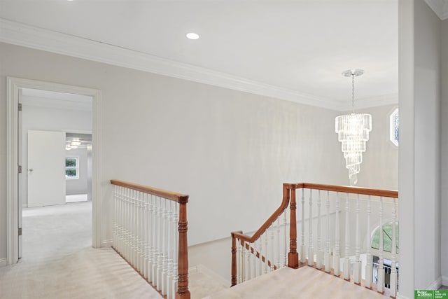 staircase with carpet, crown molding, and a chandelier