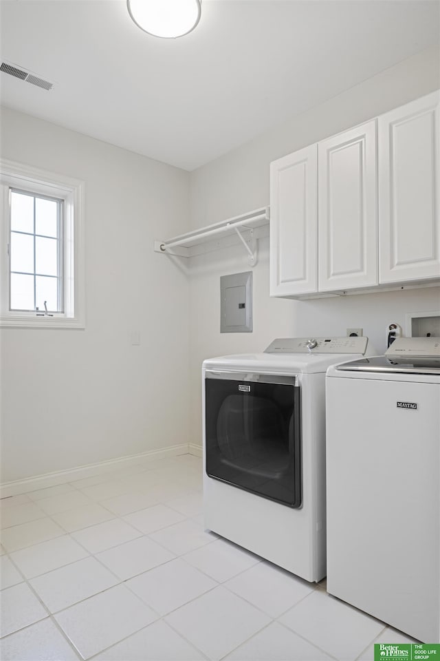 laundry room featuring light tile patterned flooring, cabinets, independent washer and dryer, and electric panel