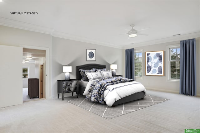 bedroom with ceiling fan, crown molding, and light colored carpet