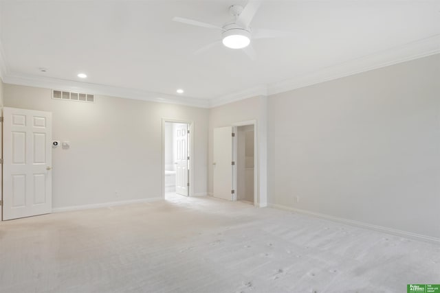 carpeted empty room featuring ceiling fan and ornamental molding