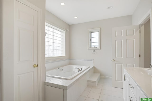 bathroom featuring vanity, tiled bath, and tile patterned floors