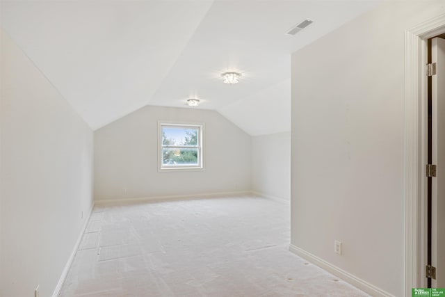 additional living space with light carpet and lofted ceiling