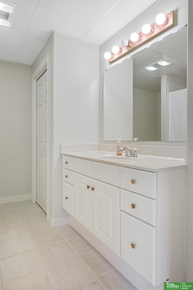 bathroom with vanity and a drop ceiling