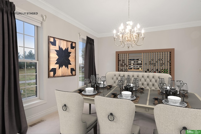 dining area featuring a chandelier, plenty of natural light, and ornamental molding