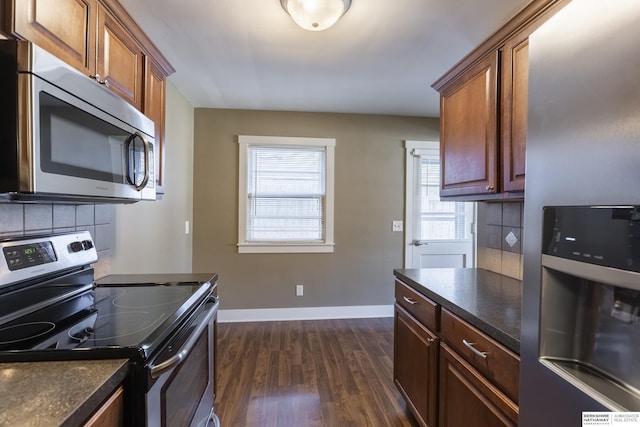 kitchen with stainless steel appliances, tasteful backsplash, and dark wood-type flooring