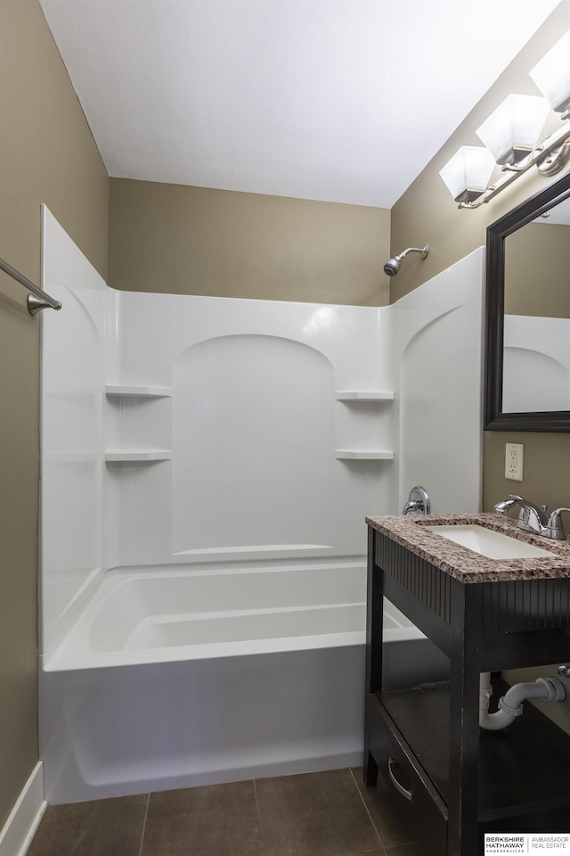 bathroom featuring tile patterned flooring, bathing tub / shower combination, and sink