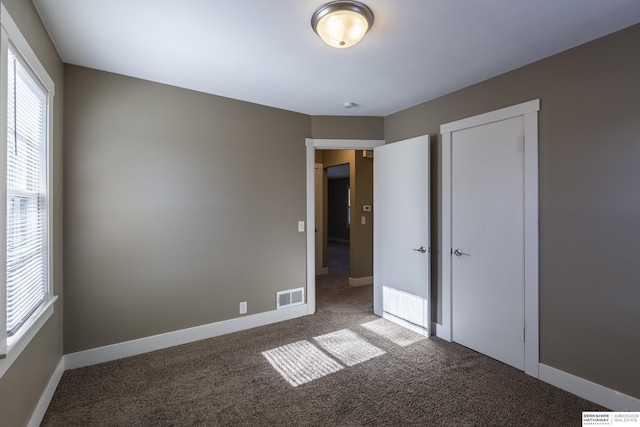 unfurnished bedroom with a closet and carpet floors