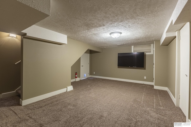 basement with carpet flooring and a textured ceiling