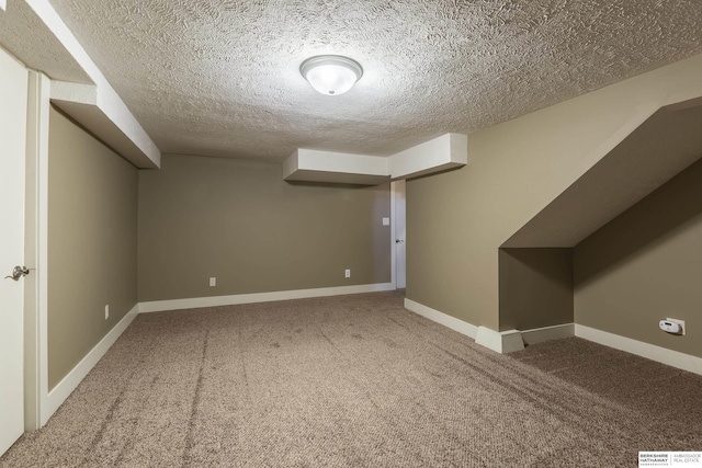 basement with a textured ceiling and carpet