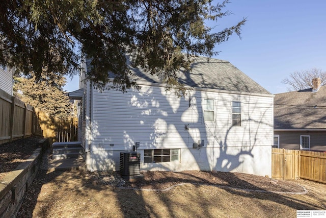 back of property featuring central AC