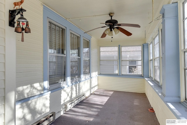 unfurnished sunroom featuring baseboard heating, a wealth of natural light, and ceiling fan