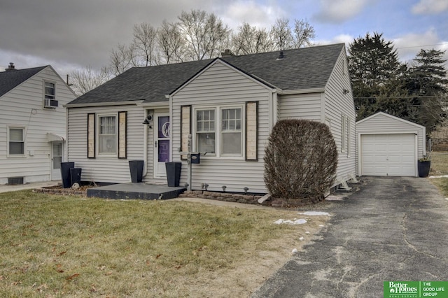 view of front of house with an outbuilding, a front lawn, and a garage