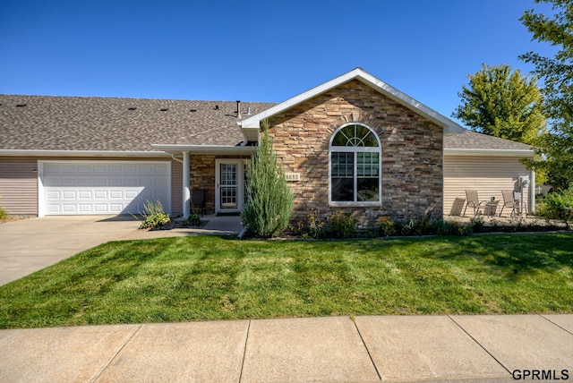 ranch-style home featuring a garage and a front lawn