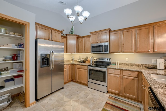 kitchen with vaulted ceiling, pendant lighting, light stone countertops, appliances with stainless steel finishes, and a chandelier