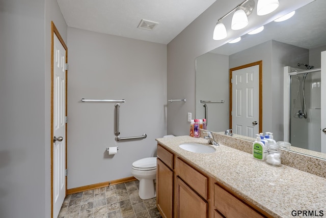 bathroom with an enclosed shower, vanity, and toilet