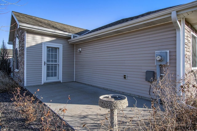 view of side of home with a patio area