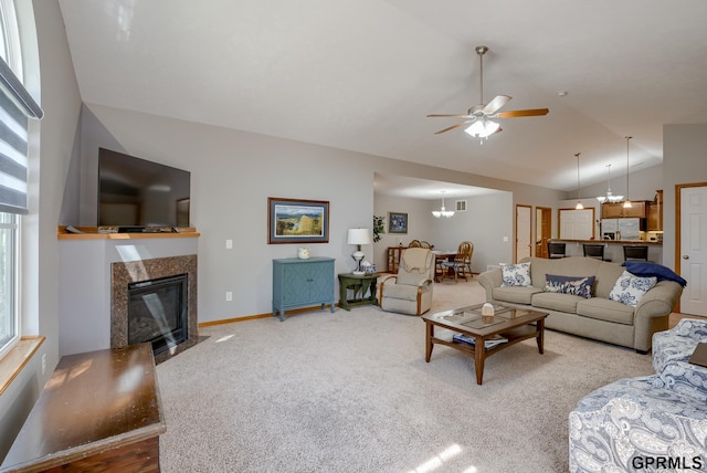 living room with carpet, lofted ceiling, and ceiling fan with notable chandelier