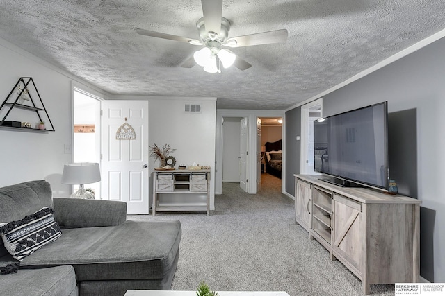 carpeted living room featuring a textured ceiling and ceiling fan