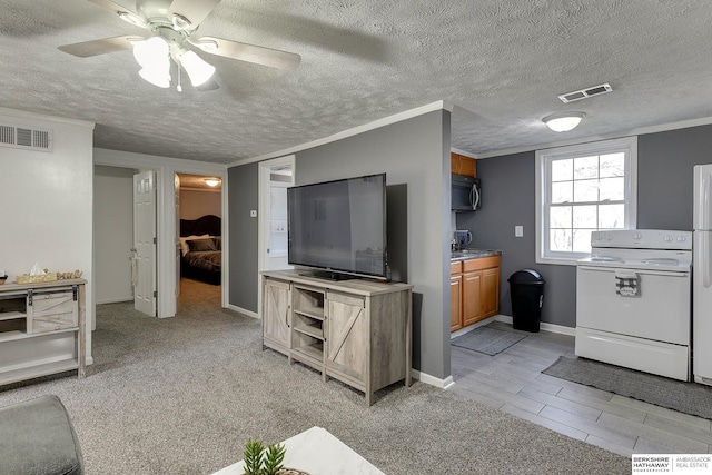 carpeted living room with ceiling fan