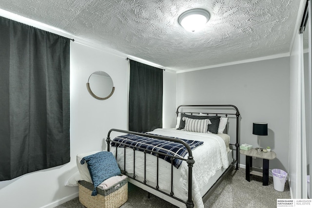 carpeted bedroom with a textured ceiling and crown molding