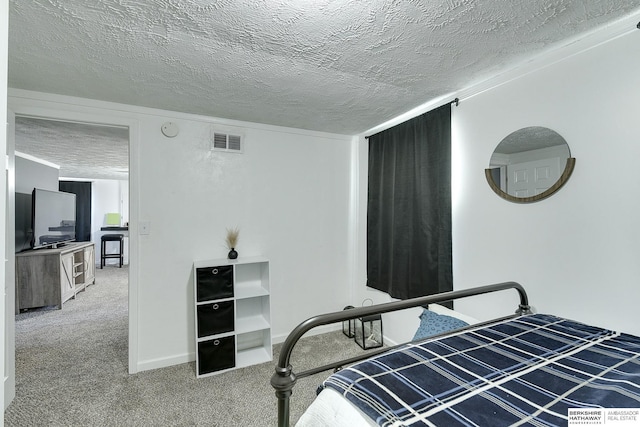 carpeted bedroom with a textured ceiling