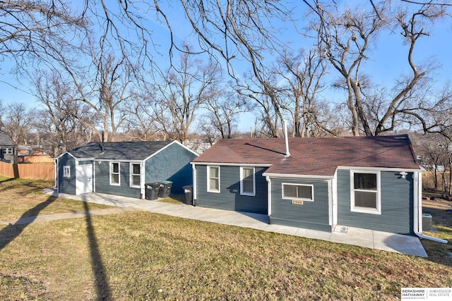 back of property with a patio area, an outdoor structure, and a lawn