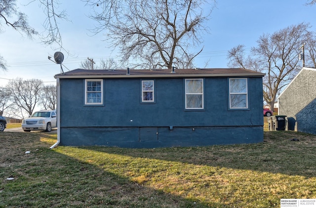 view of side of property with a lawn