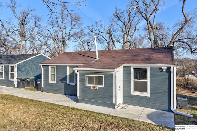 exterior space featuring a front yard and central AC unit