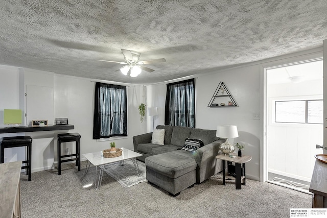 carpeted living room featuring ceiling fan