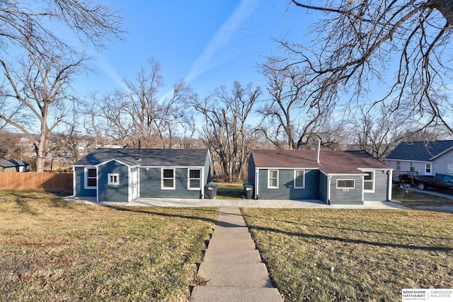 single story home featuring a front yard and a patio area