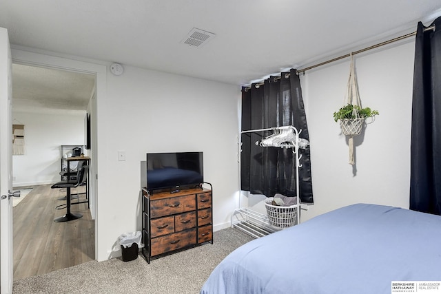 bedroom with wood-type flooring