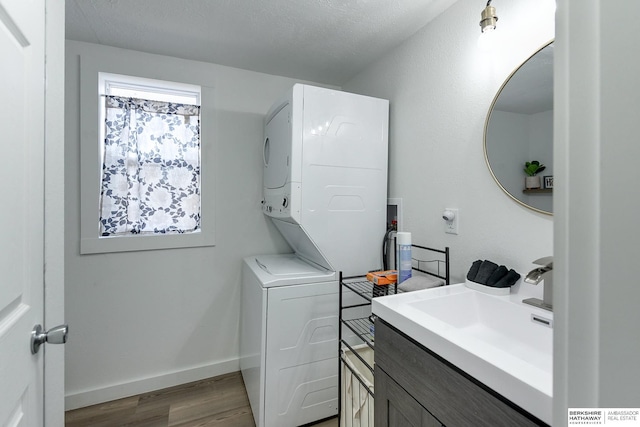 bathroom with wood-type flooring, vanity, and a textured ceiling