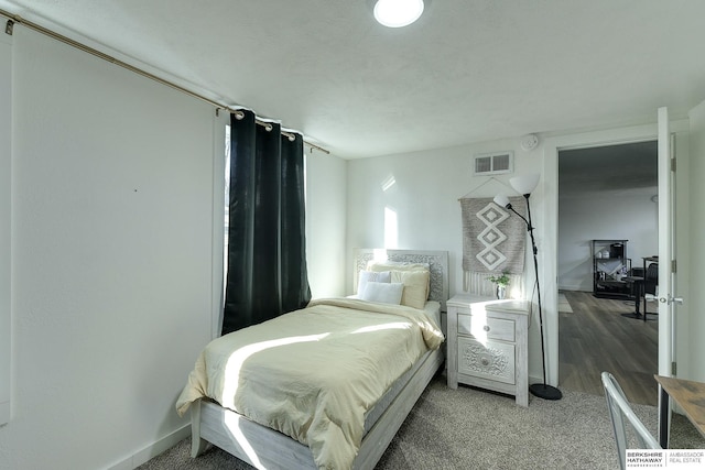 bedroom with hardwood / wood-style flooring