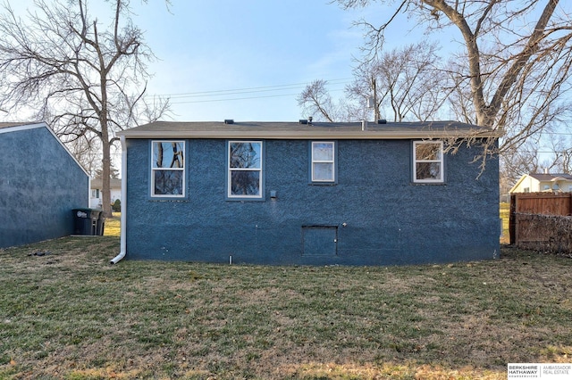 rear view of house featuring a yard