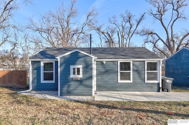 view of property exterior with a patio and a yard