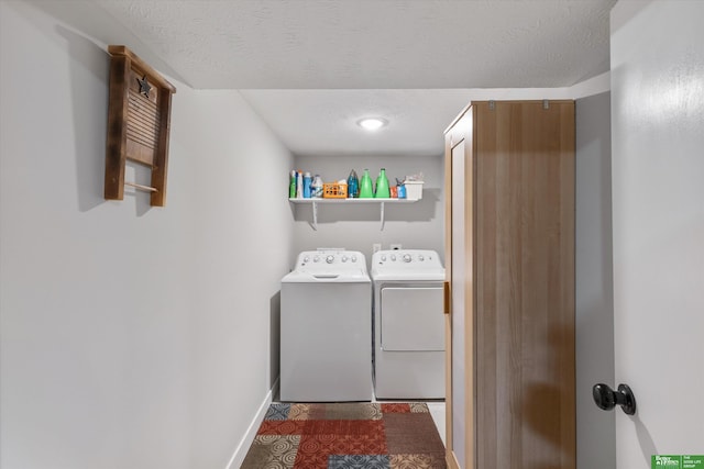 laundry area featuring a textured ceiling and washing machine and clothes dryer