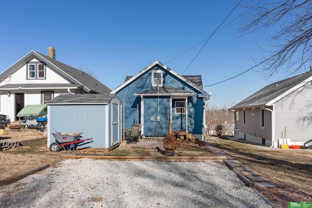 view of front of property with a storage shed